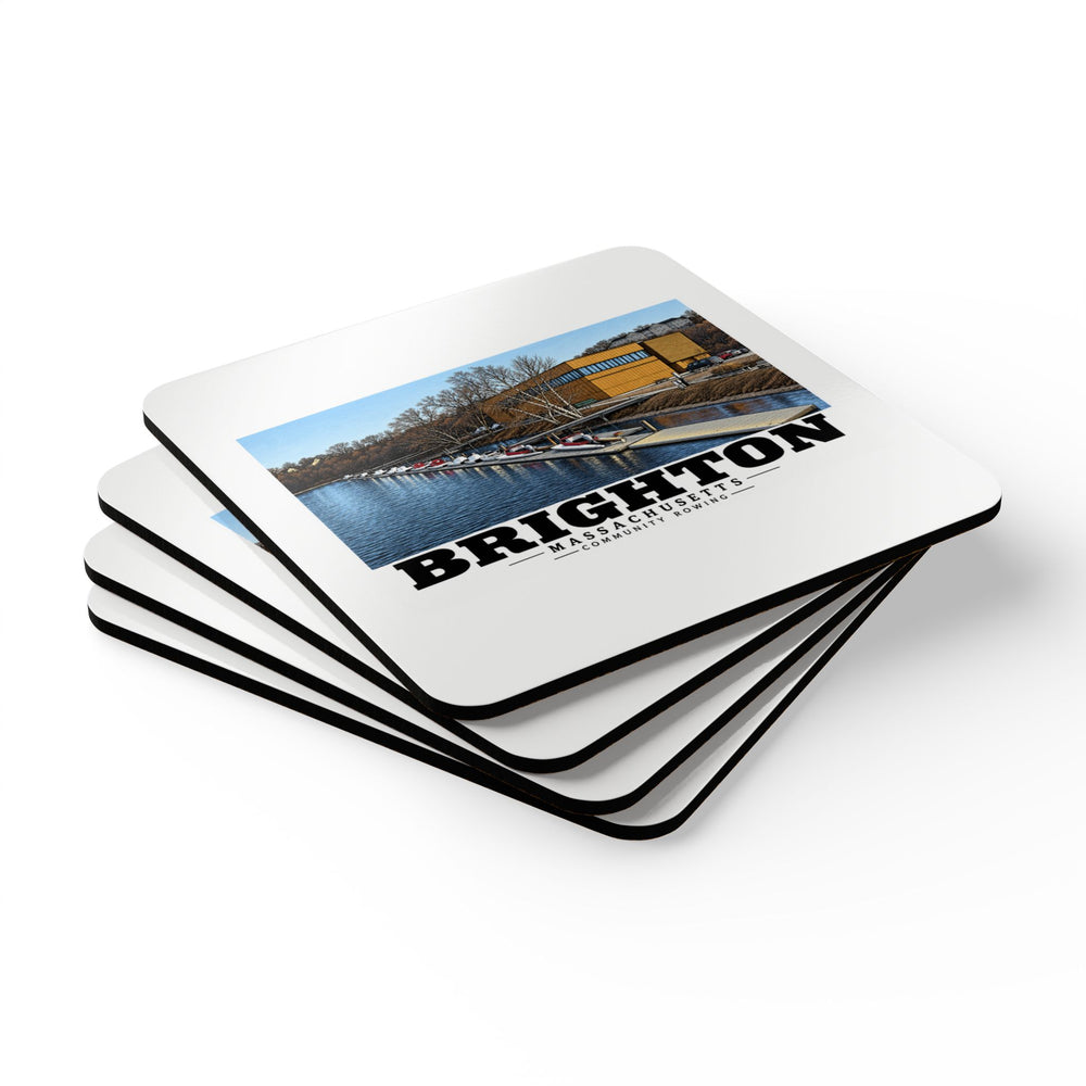 Stack of square coasters with Community Rowing building, dock and boats artwork visible on the top coaster