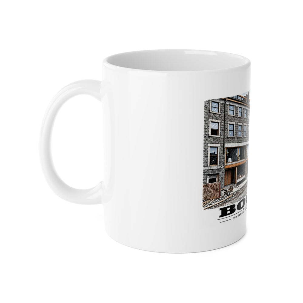White mug with handle at left and part of the Commercial Wharf Street buildings, blue van and renovation debris print at right