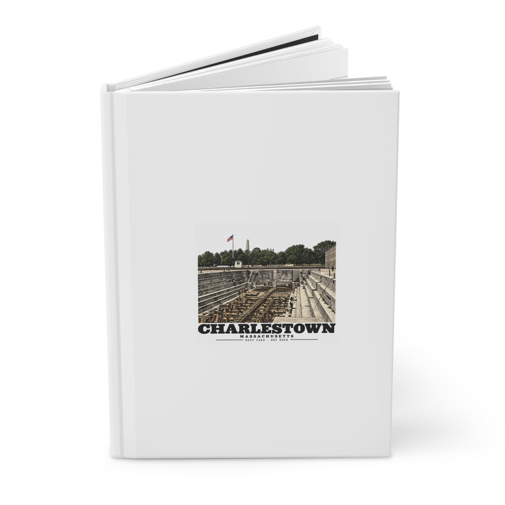Partly open dry-dock hardcover journal showing printed front cover