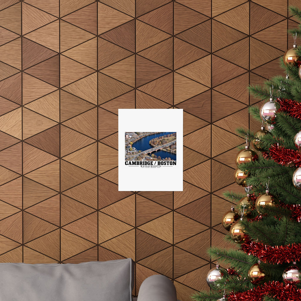 Eliot Bridge aerial river view poster on a wood wall beside a decorated evergreen