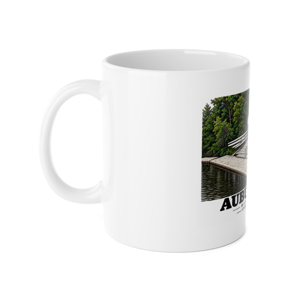 Left-handle view of the white ceramic mug with Stoller Boathouse artwork partly visible.