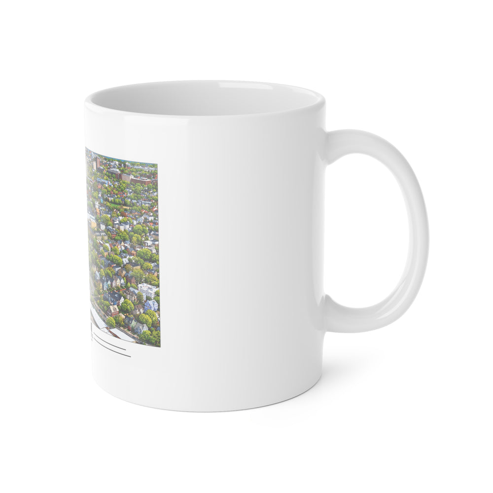 White mug with handle at right and part of the Charles River aerial city view with bridges, buildings and green trees print at left