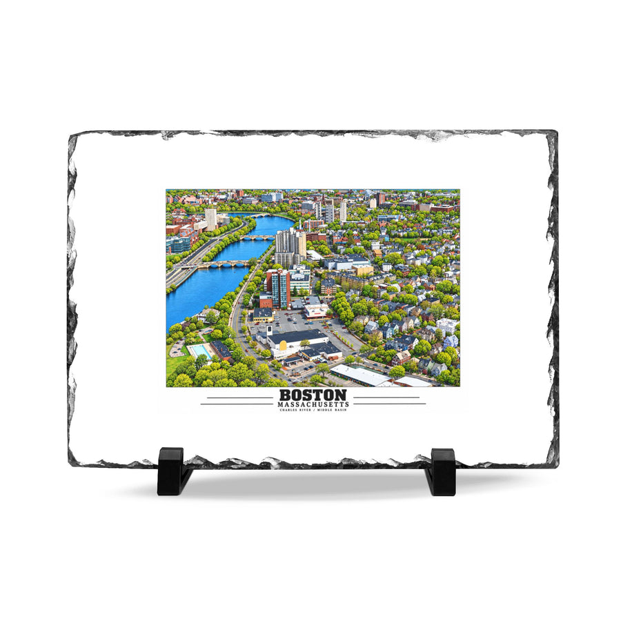 Rough-edged slate display on two black stands with Charles River aerial city view with bridges, buildings and green trees artwork and Boston lettering