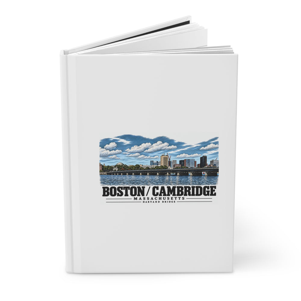 Partly opened white hardcover journal showing Harvard Bridge river and skyline view artwork on the front