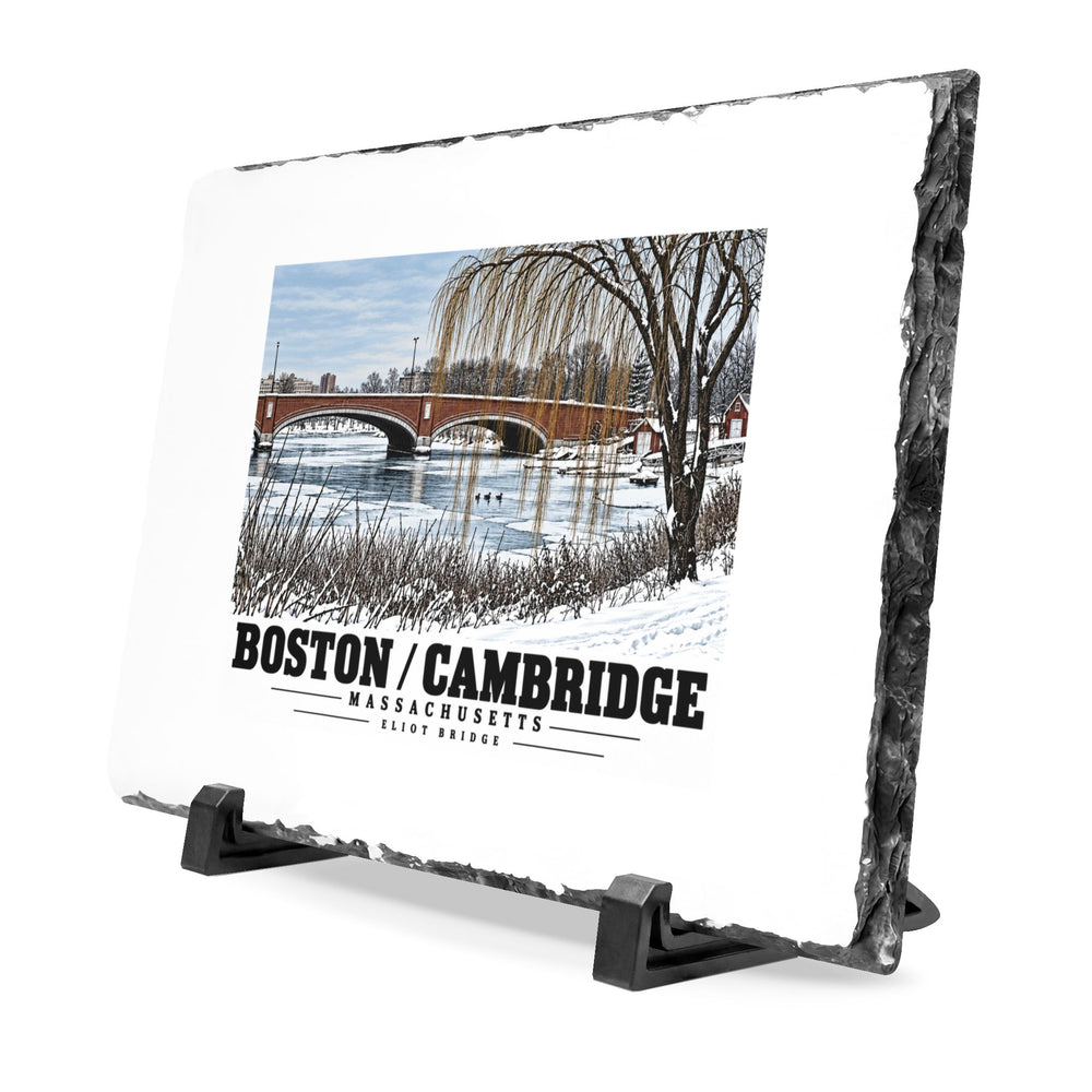 Angled rough-edged slate display on black stands showing Eliot Bridge winter river view with snow and bare trees artwork