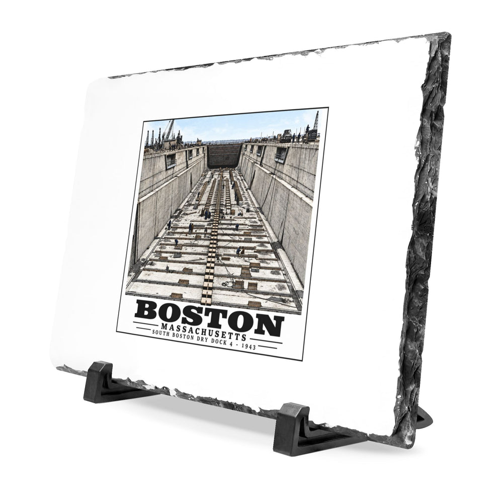 Angled rough-edged slate display on black stands showing naval dry dock with concrete walls and rows of floor blocks artwork