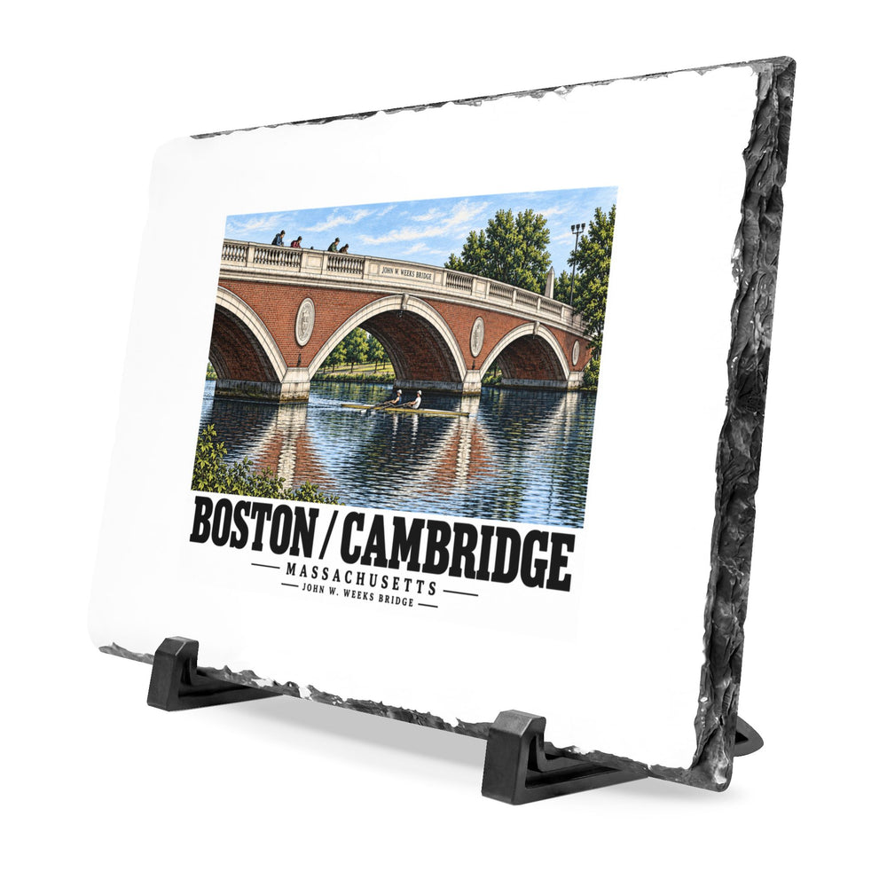 Angled rough-edged slate display on black stands showing John W. Weeks Bridge and scullers artwork