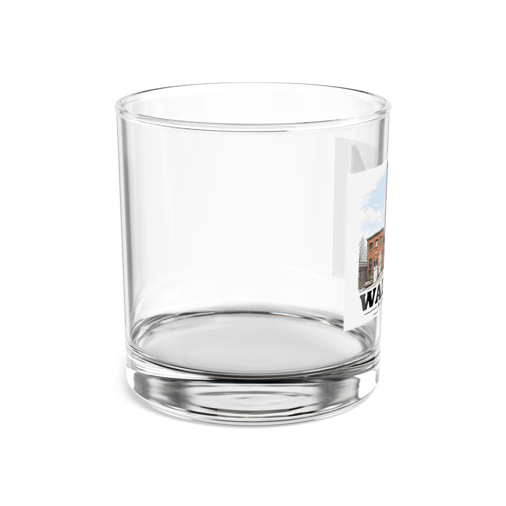 Right-side view of the clear rocks glass with Boston Manufacturing Company artwork partly visible.