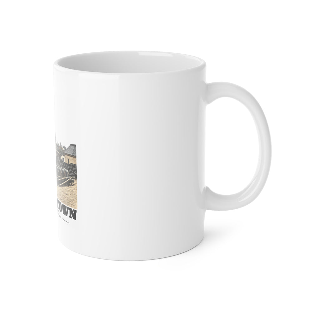 Right side of ceramic mug showing handle and edge of Water Battery artwork