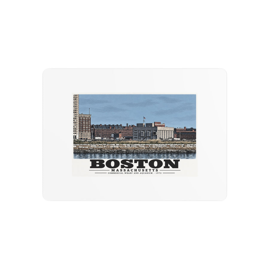 Metal wall print showing Commercial Wharf and Aquarium waterfront buildings, stone seawall and harbor water artwork and Boston lettering