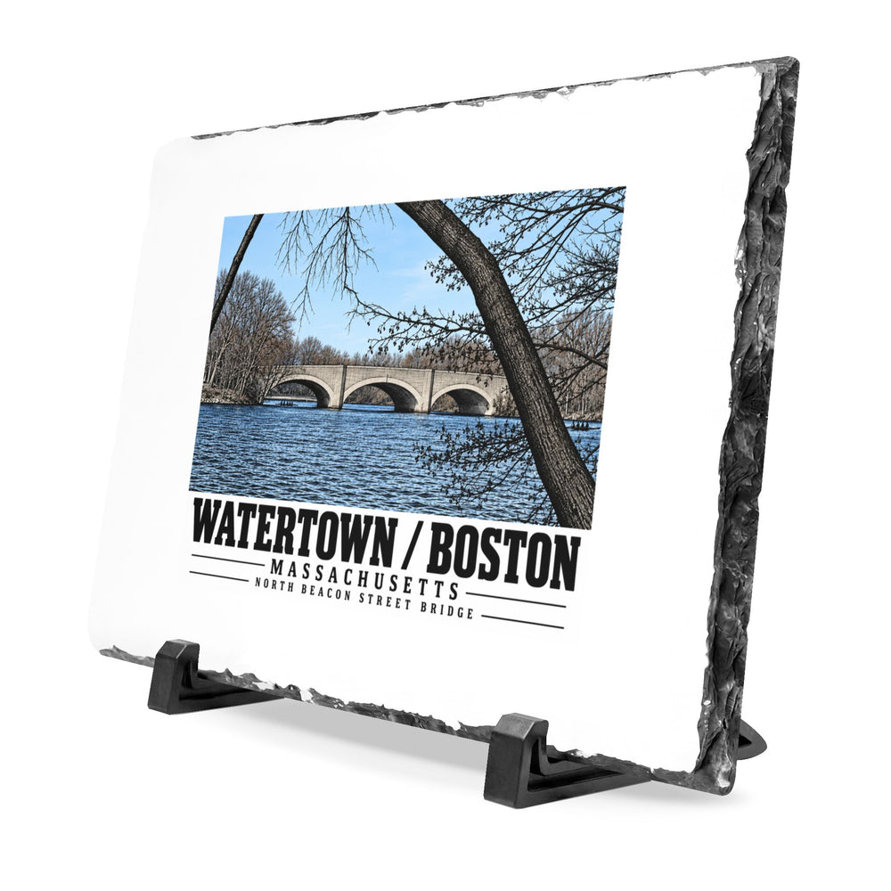 Angled rough-edged slate display on black stands showing North Beacon Street Bridge stone arches framed by a bare tree artwork