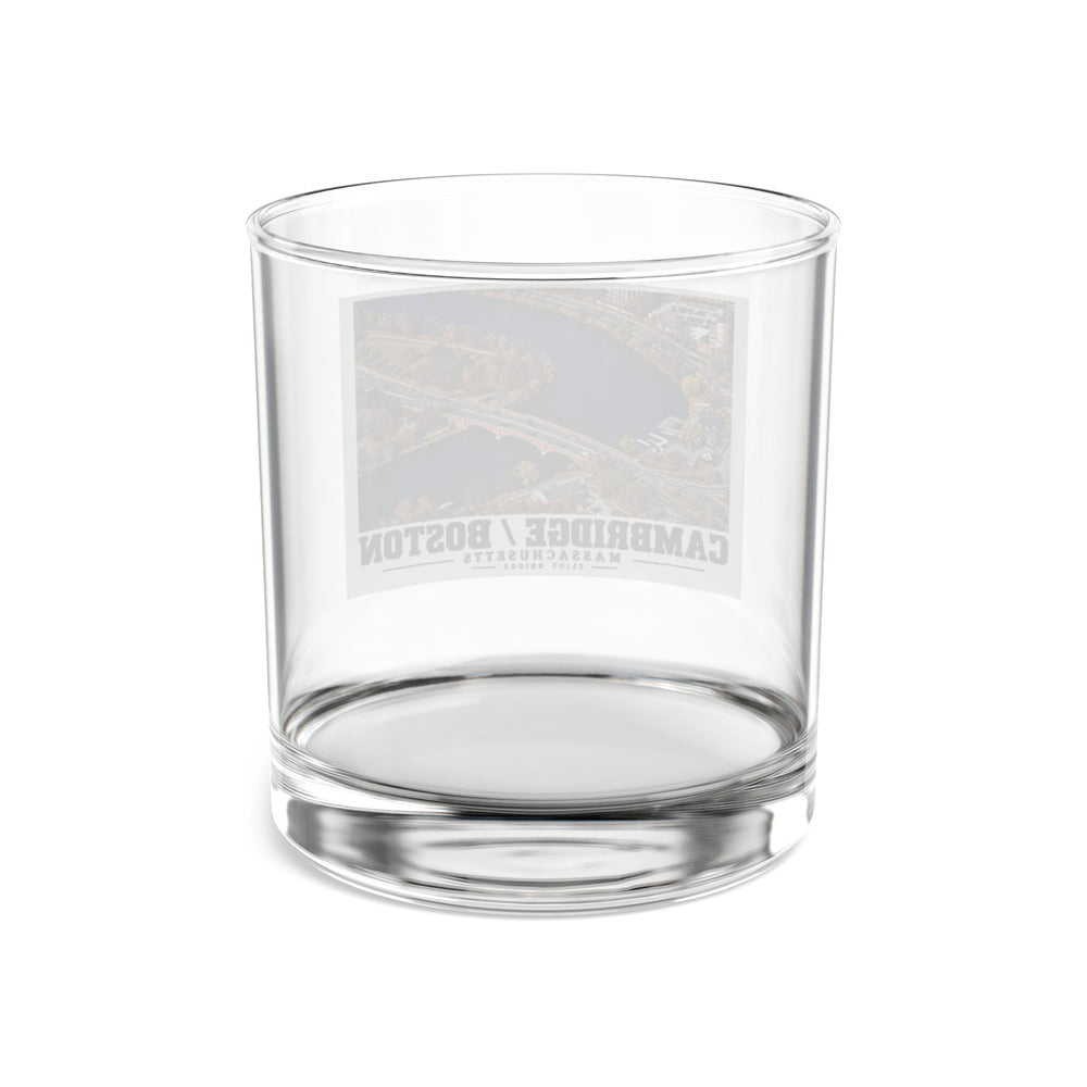 Rear view of clear rocks glass with Eliot Bridge aerial river view print and reversed lettering visible through the glass
