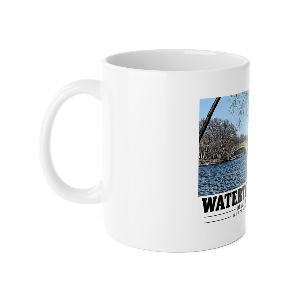 White mug with handle at left and part of the North Beacon Street Bridge stone arches framed by a bare tree print at right