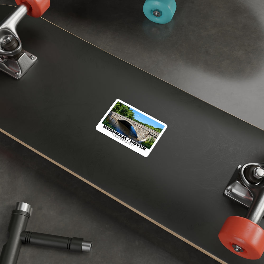 Sticker showing South Street Bridge stone arch and river artwork on the underside of a skateboard