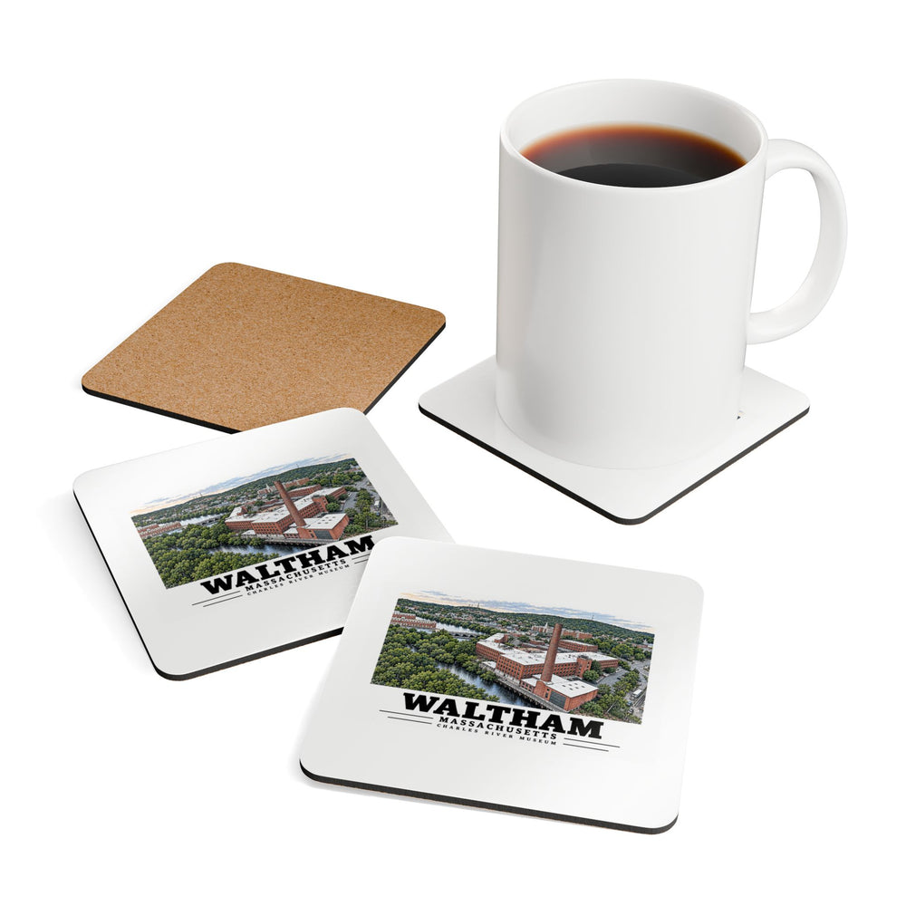 Coffee mug resting on a Charles River Museum coaster beside printed coasters and an exposed cork back.