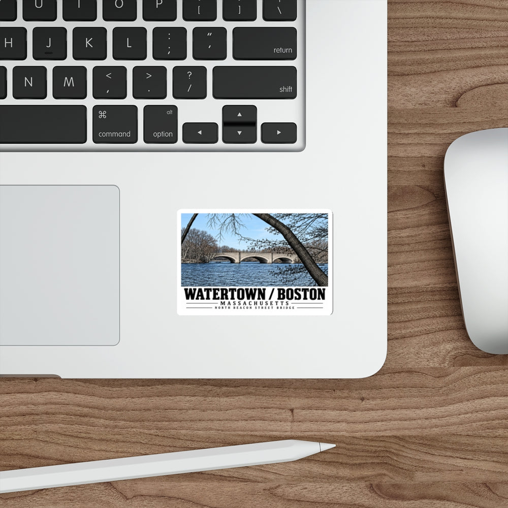 Sticker showing North Beacon Street Bridge stone arches framed by a bare tree artwork on a laptop beside its keyboard
