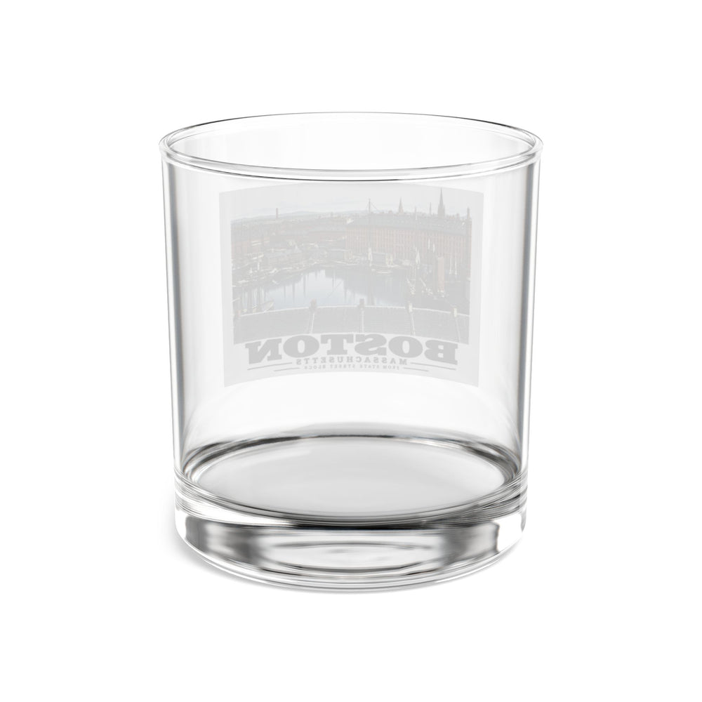 Rear view of clear rocks glass with Boston waterfront buildings, wharves, boats and harbor water print and reversed lettering visible through the glass