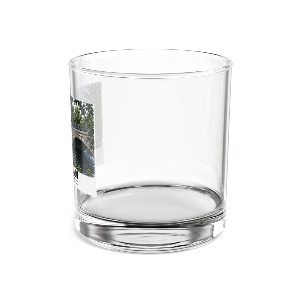 Side view of clear rocks glass with mostly unprinted surface and part of Prospect Street Bridge stone arches and river print at left