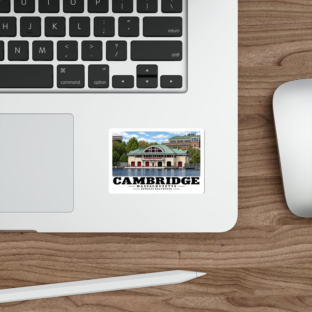 Cambridge DeWolfe Boathouse sticker on a laptop beside a keyboard and mouse.