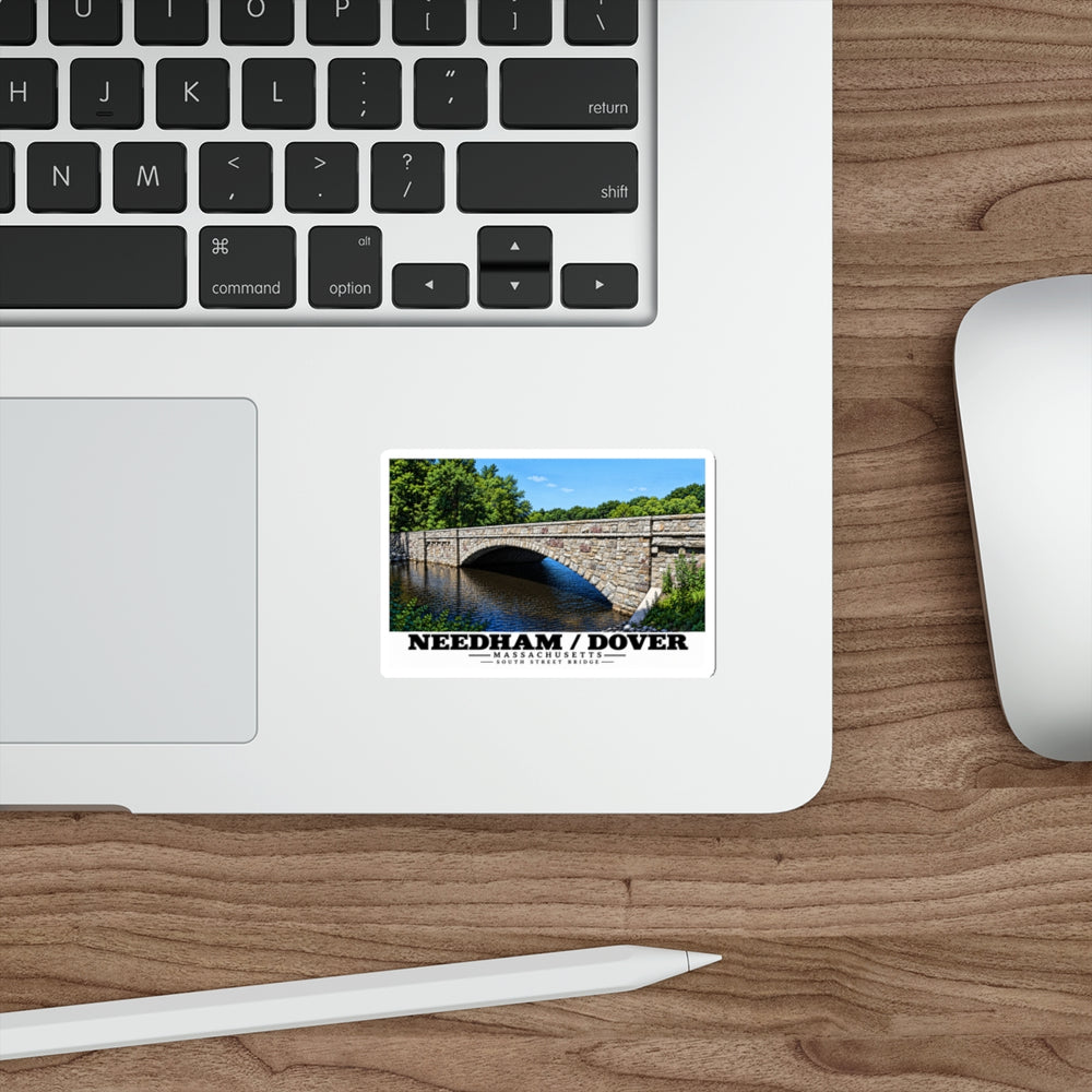Sticker showing South Street Bridge stone arch and river artwork on a laptop beside its keyboard