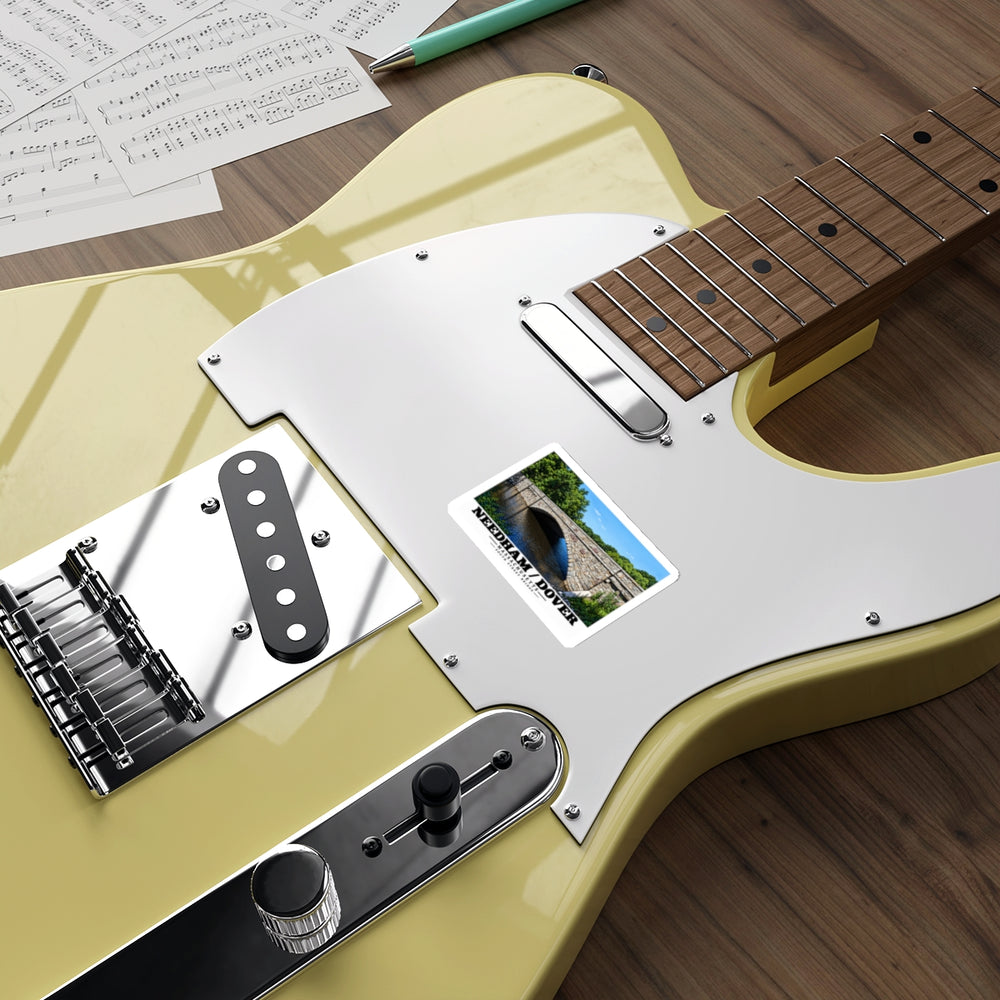 Sticker showing South Street Bridge stone arch and river artwork on a pale yellow electric guitar