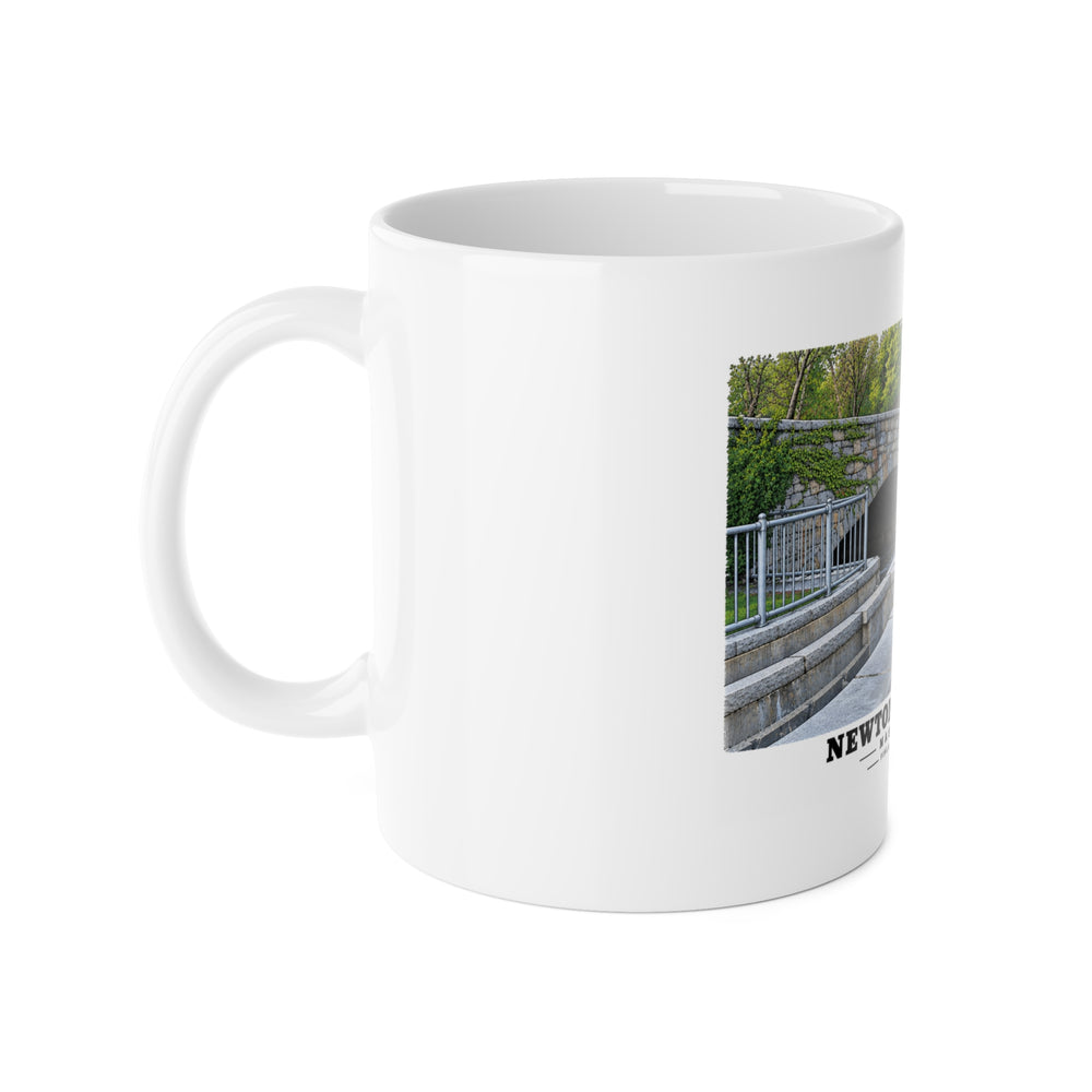 White mug with handle at left and part of the Finlay Dam stone arches and water print at right