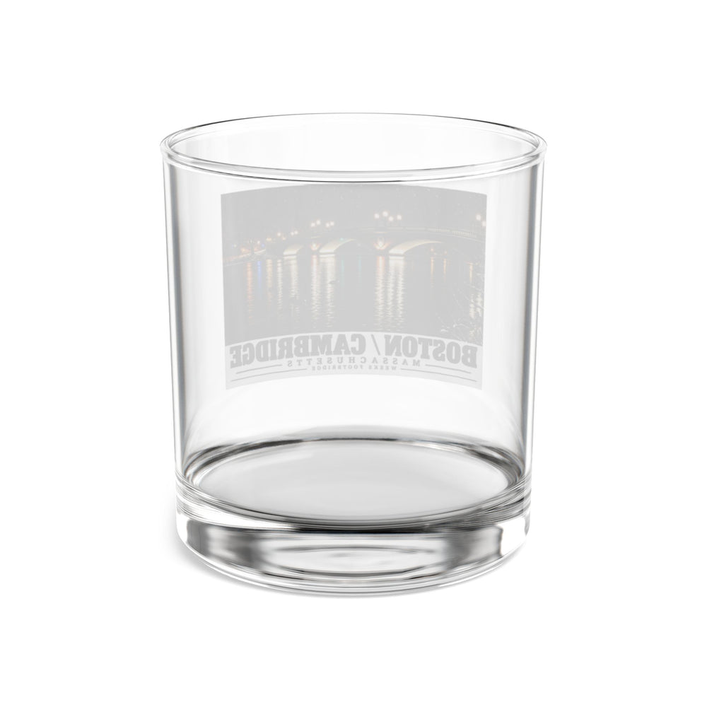 Rear view of clear rocks glass with Weeks Footbridge illuminated night view with water reflections print and reversed lettering visible through the glass