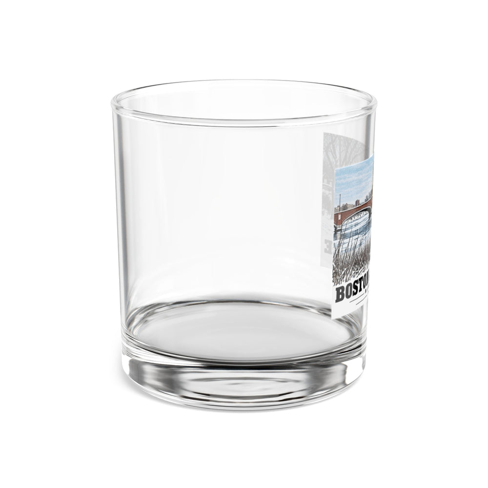 Side view of clear rocks glass with mostly unprinted surface and part of Eliot Bridge winter river view with snow and bare trees print at right