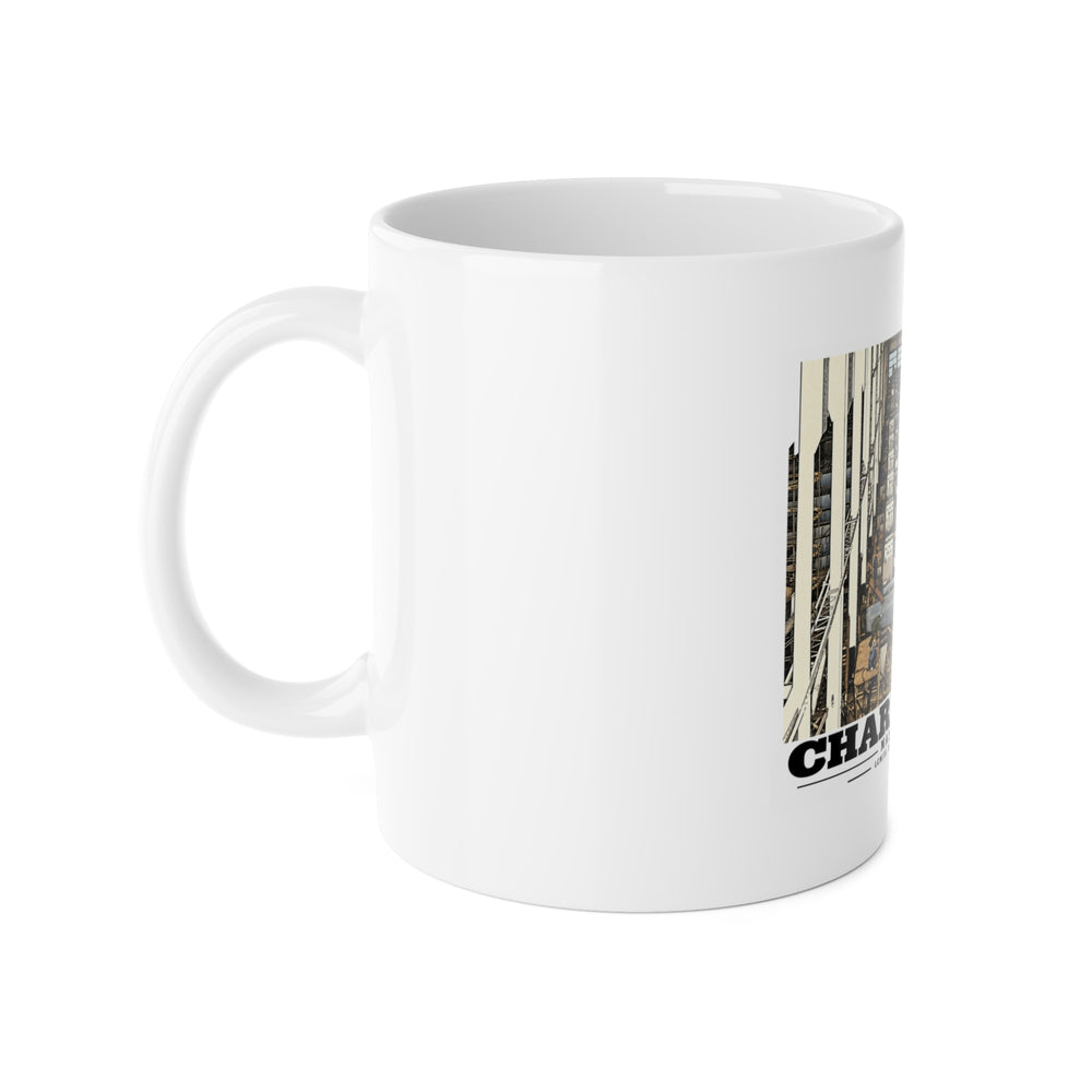 Left side of white ceramic mug showing handle and partial landing-craft production line artwork