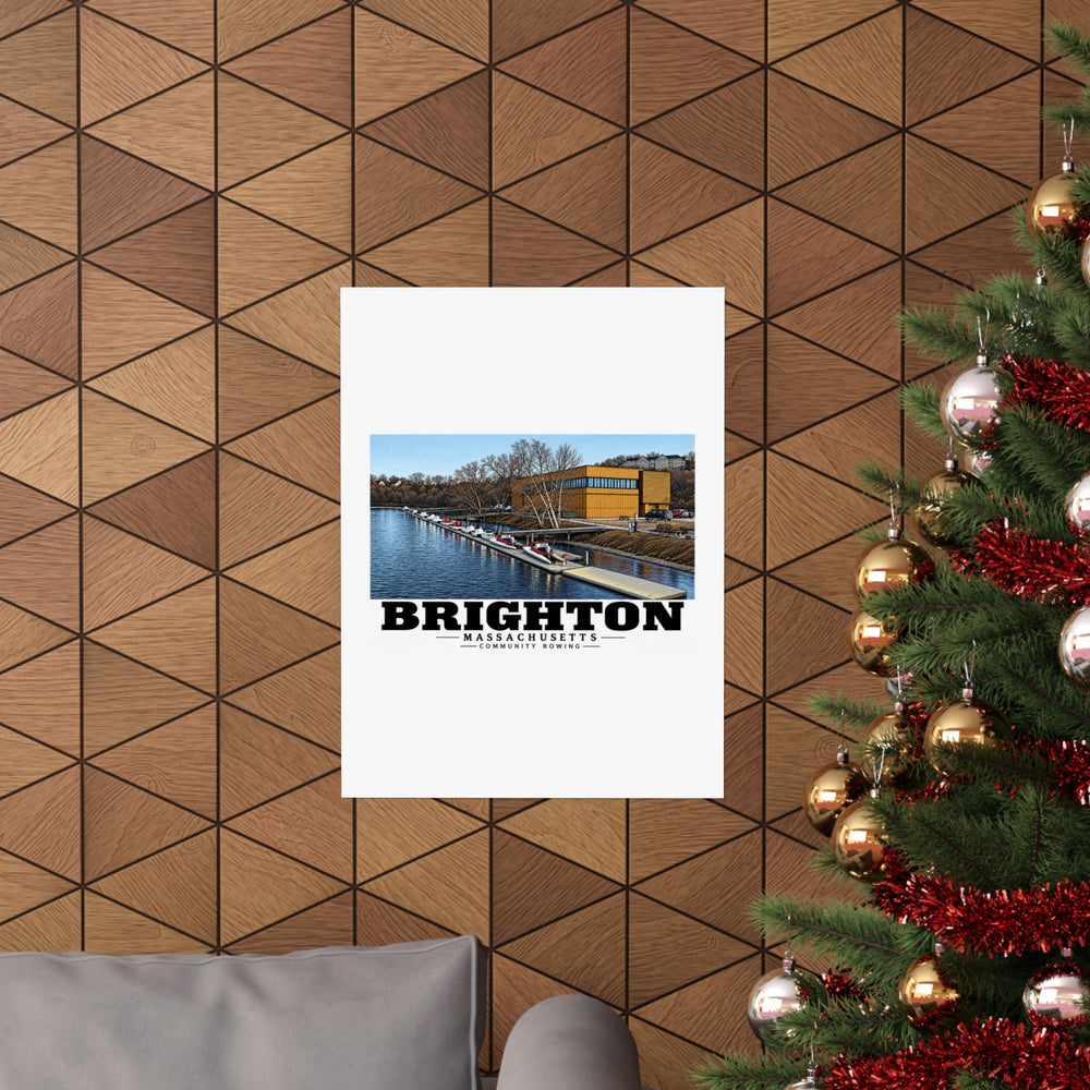 Community Rowing building, dock and boats poster on a wood wall beside a decorated evergreen