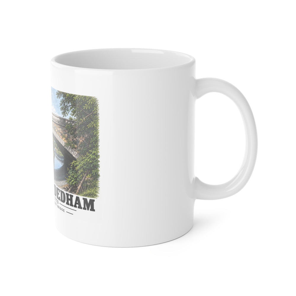White mug with handle at right and part of the Greendale Avenue / Lyons Street Bridge stone arch and reflection print at left