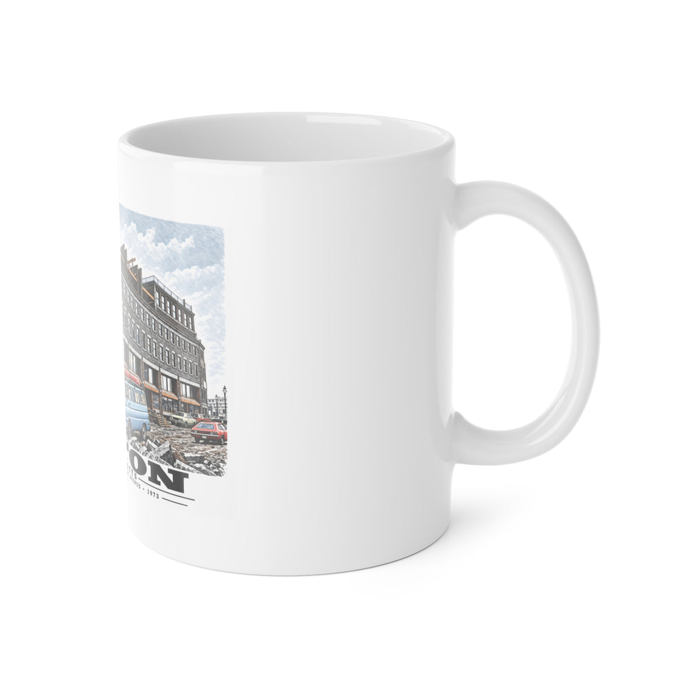 White mug with handle at right and part of the Commercial Wharf Street buildings, blue van and renovation debris print at left