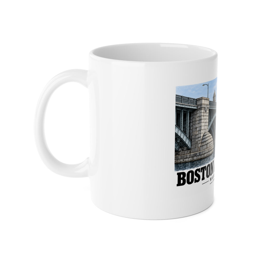 White ceramic mug with its handle on the left and part of the Longfellow Bridge design visible on the right.