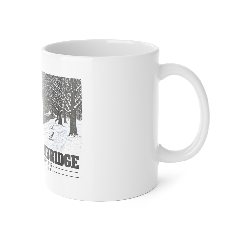 White mug with handle at right and part of the Weeks Footbridge winter riverbank view with snow and benches print at left