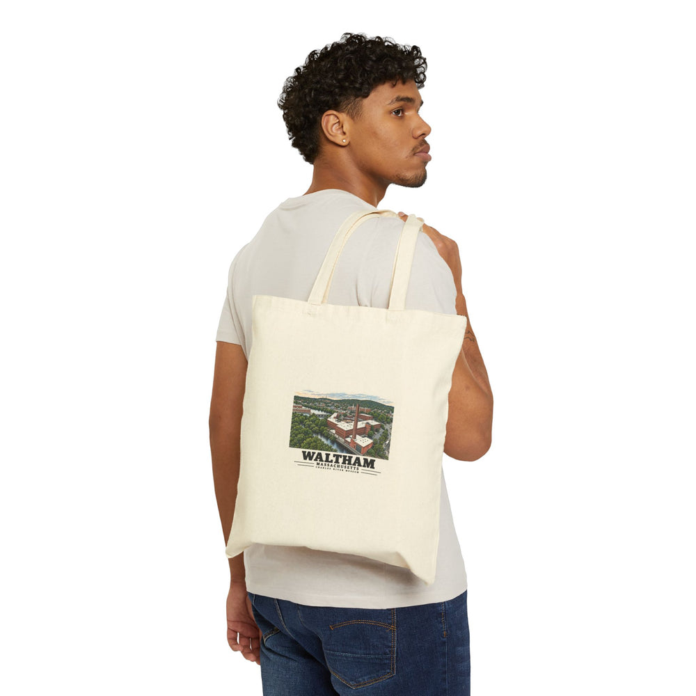 Person carrying the natural canvas tote with Charles River Museum artwork facing outward.