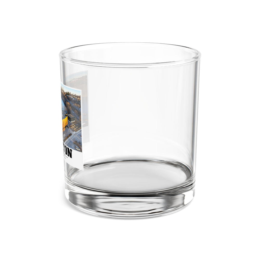 Side view of clear rocks glass with mostly unprinted surface and part of Community Rowing aerial building and river print at left