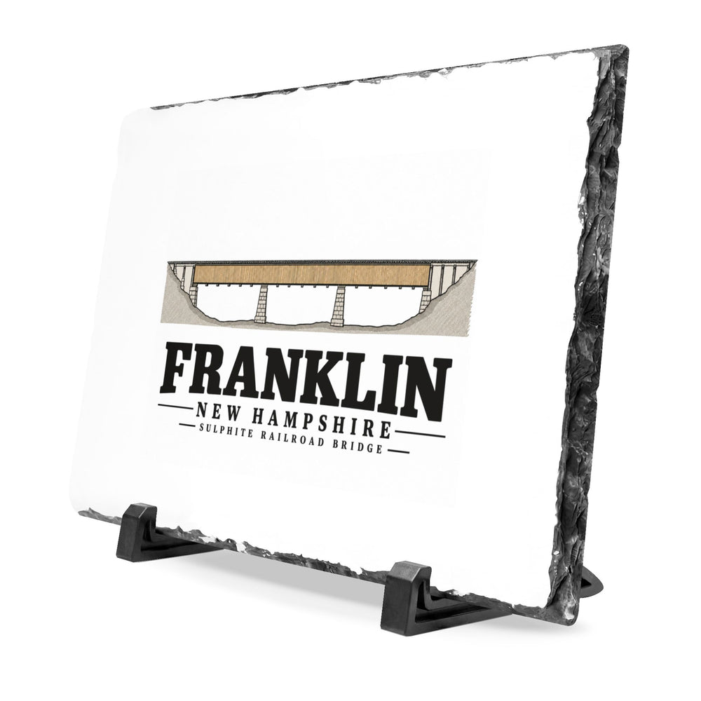Angled front on display stands of Sulphite Railroad Bridge slate desk plaque, with Franklin, New Hampshire artwork and lettering.