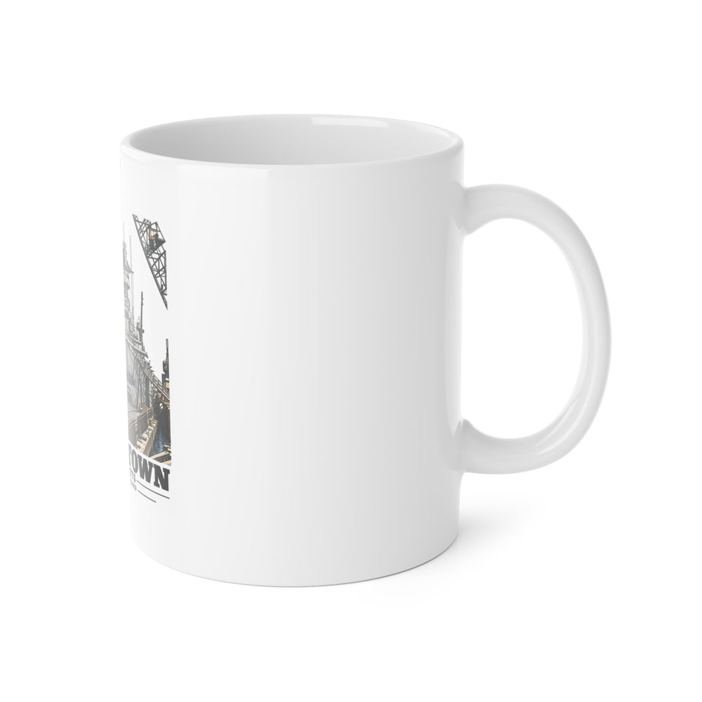Right side of ceramic mug showing handle and edge of USS Arkansas artwork