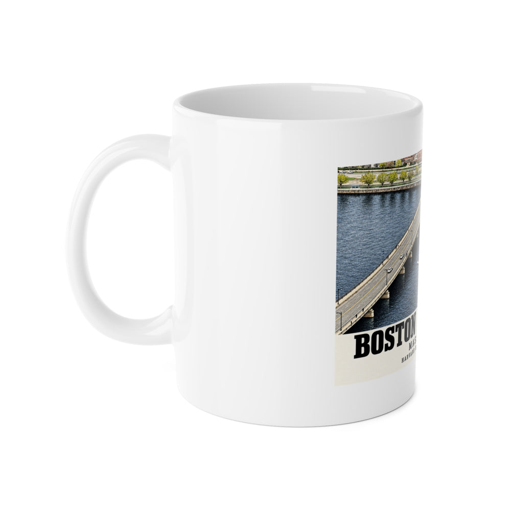 White mug with handle at left and part of the Harvard Bridge aerial view with scullers on the Charles River print at right