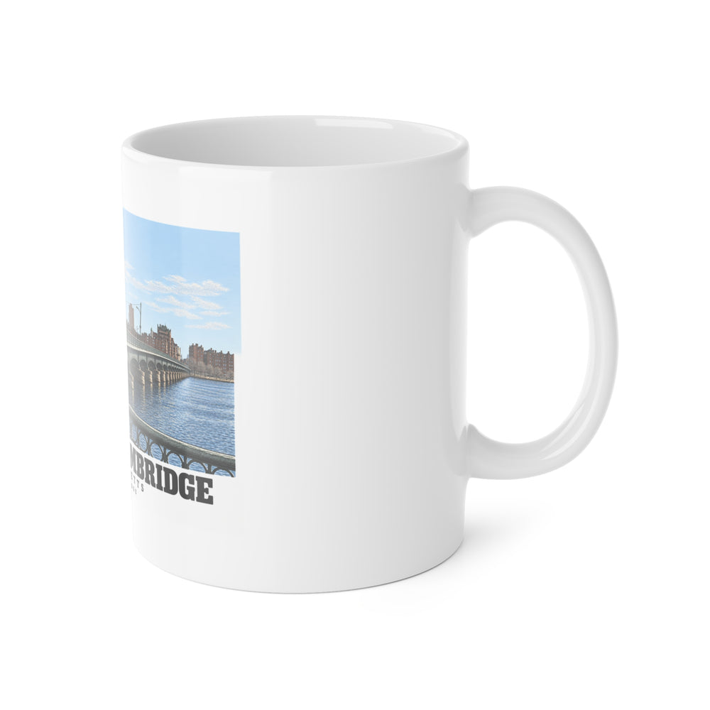 White mug with handle on the right and part of the Harvard Bridge print visible on the left