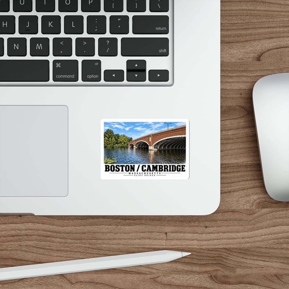 Sticker showing Eliot Bridge close red brick arch view artwork on a laptop beside its keyboard