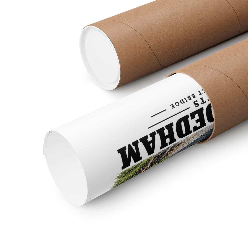Partly rolled poster extending from a cardboard tube with partial Dedham lettering and a narrow strip of the printed scene visible