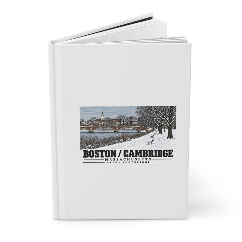 Partly opened white hardcover journal showing Weeks Footbridge winter riverbank view with snow and benches artwork on the front