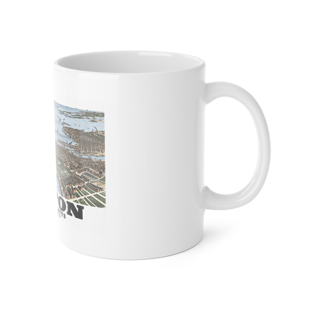 White mug with handle at right and part of the historic Boston harbor panorama with boats and waterfront buildings print at left