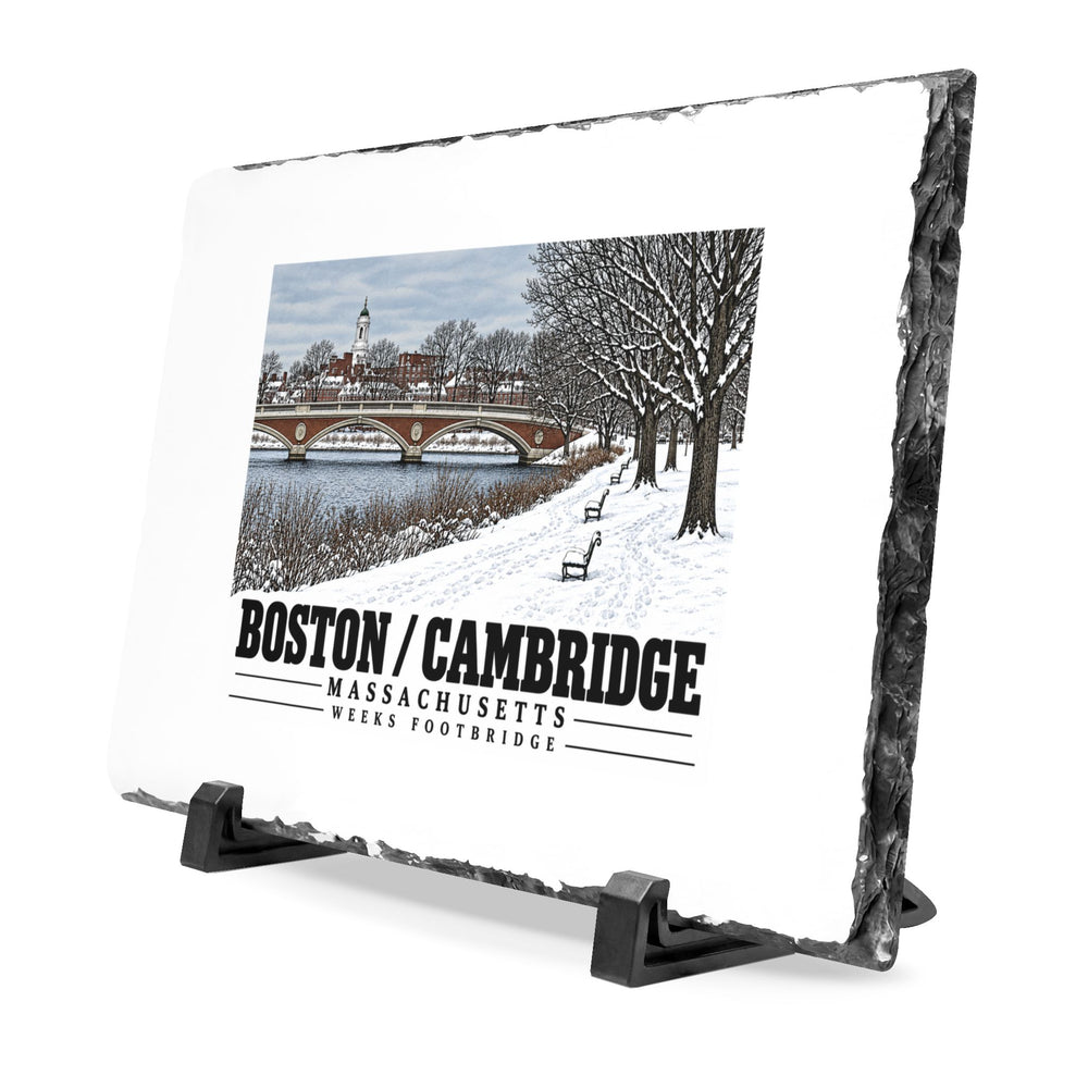 Angled rough-edged slate display on black stands showing Weeks Footbridge winter riverbank view with snow and benches artwork