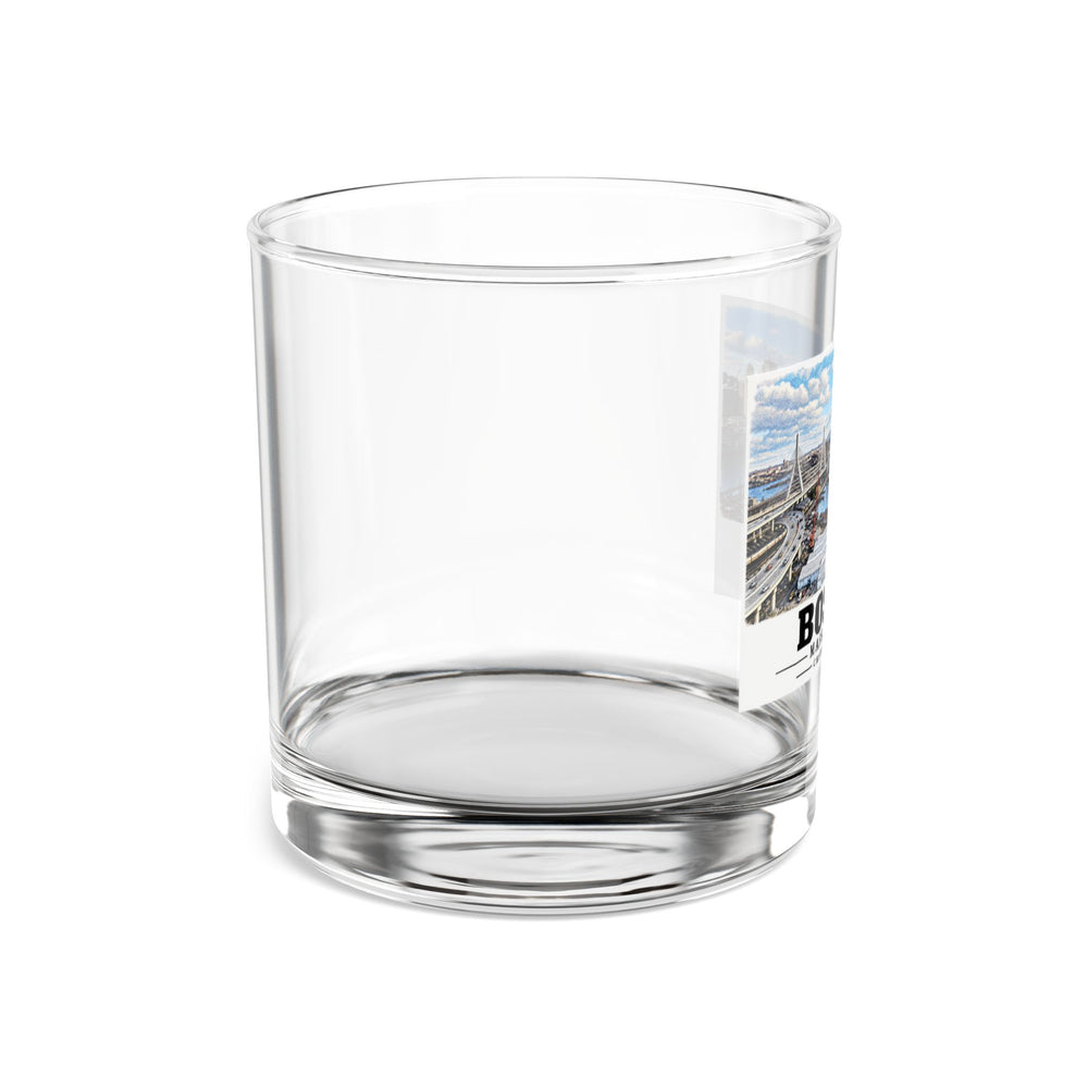 Side view of clear rocks glass with mostly unprinted surface and part of Boston skyline, cable-stayed bridge and Charles River basin print at right