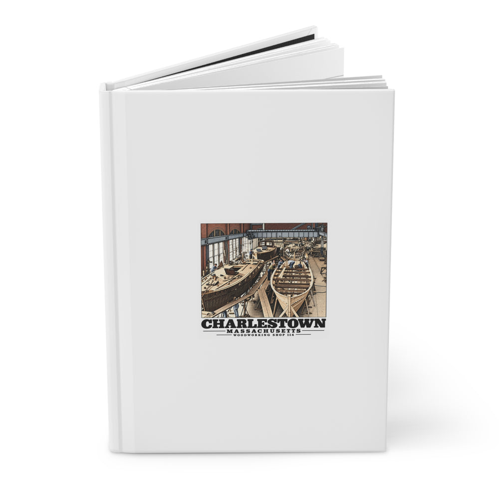 Partly open small-boat building hardcover journal showing printed front cover