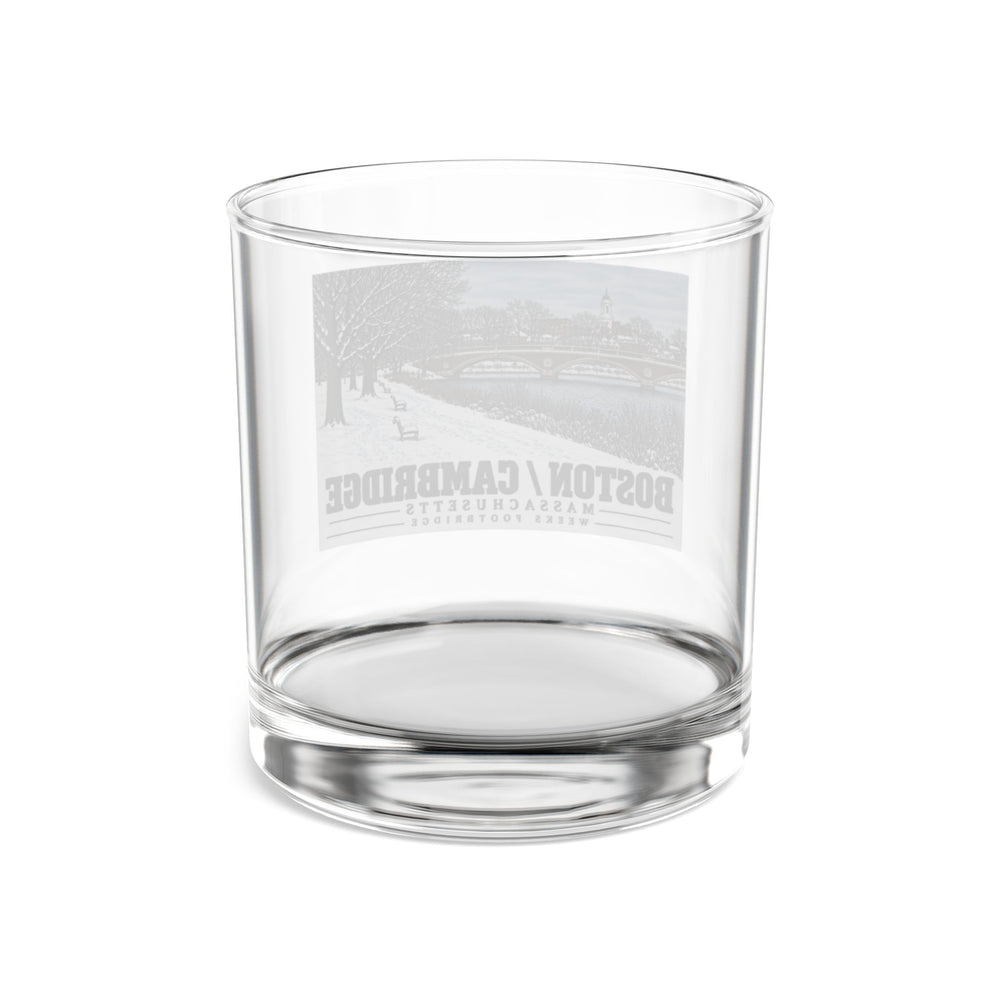 Rear view of clear rocks glass with Weeks Footbridge winter riverbank view with snow and benches print and reversed lettering visible through the glass