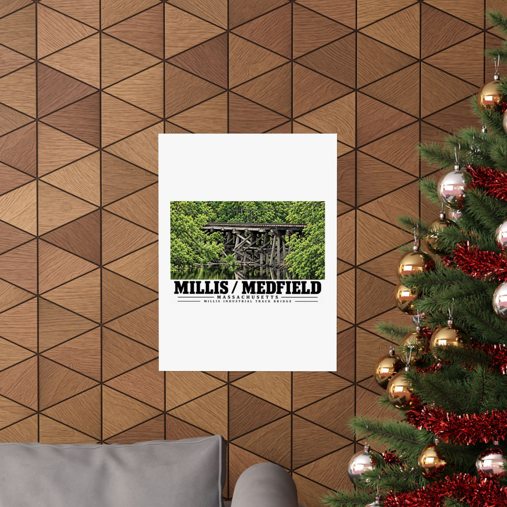 Millis Industrial Track wooden railway trestle and green foliage poster on a wood wall beside a decorated evergreen