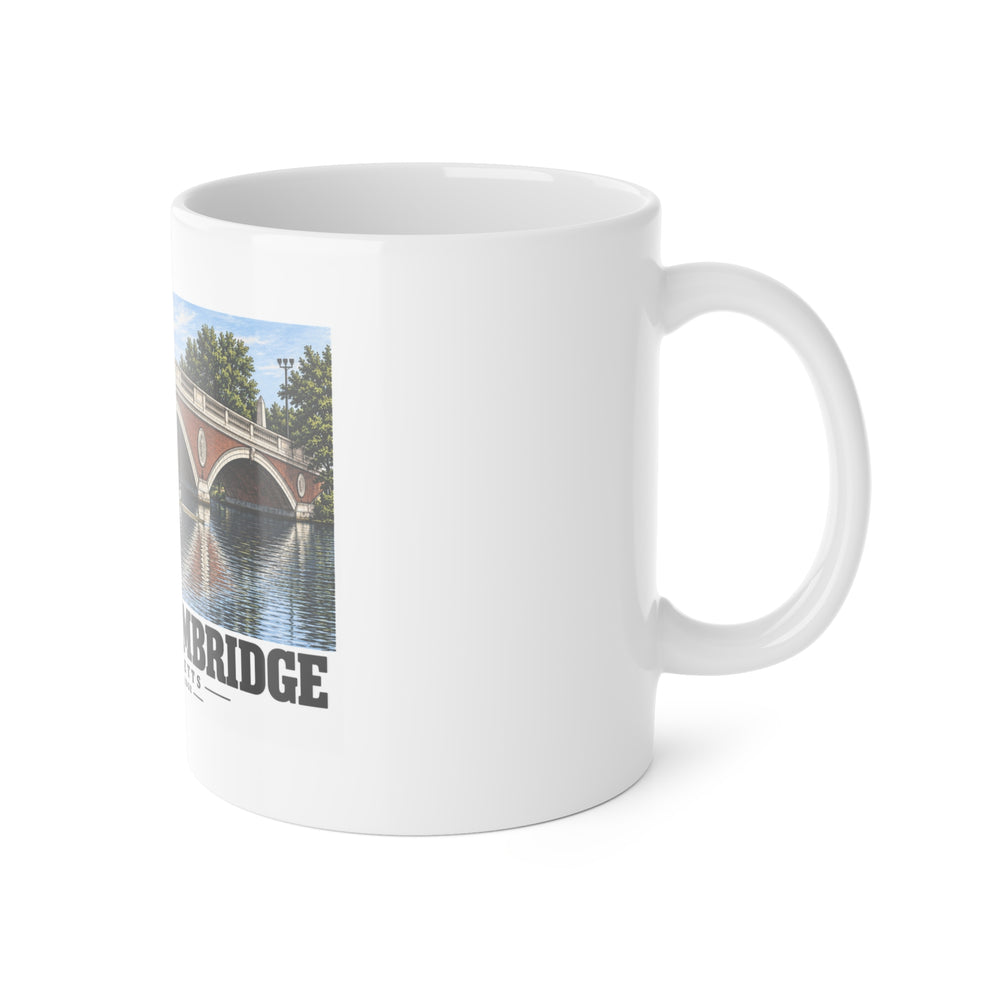 White mug with handle at right and part of the John W. Weeks Bridge and scullers print at left
